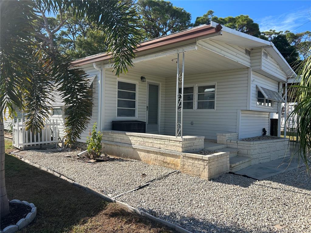 5325 Boca Raton Avenue Sarasota, FL 34234 - Photo 32 of 50 a front view of a house with garden