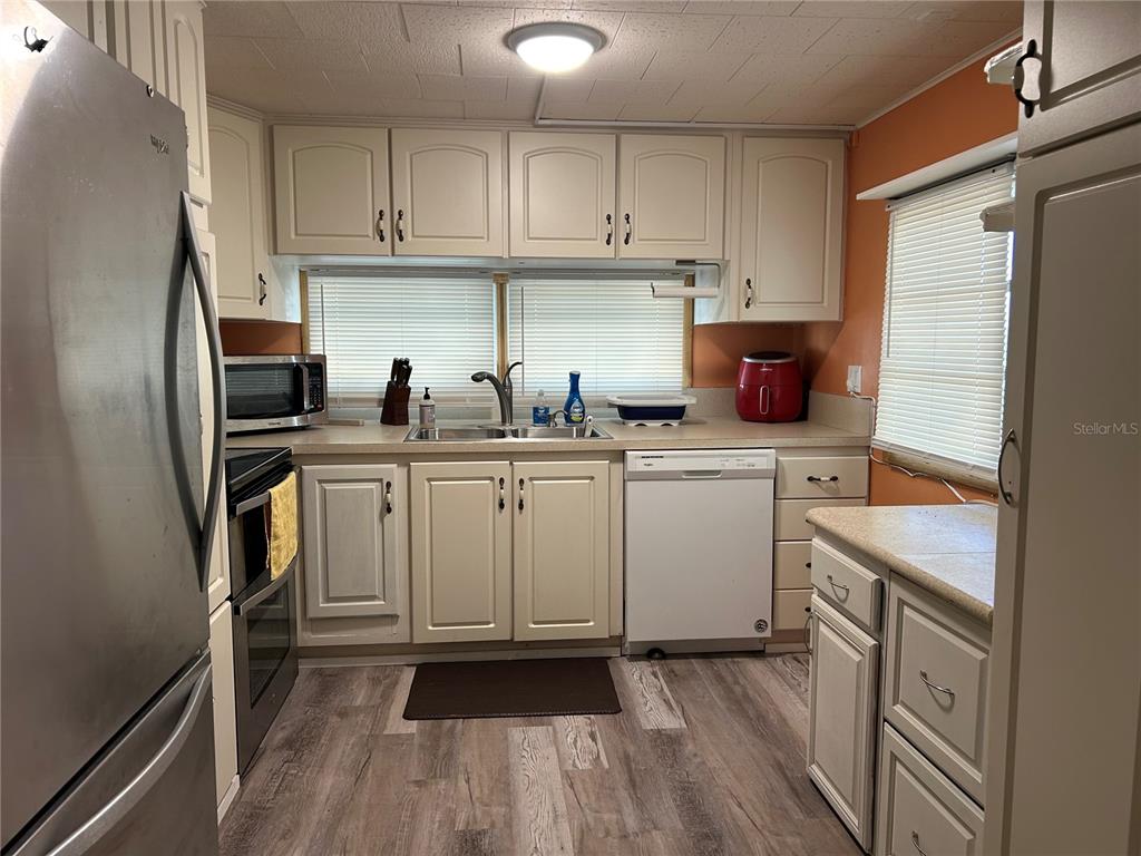 5325 Boca Raton Avenue Sarasota, FL 34234 - Photo 5 of 50 a kitchen with white cabinets sink and stainless steel appliances
