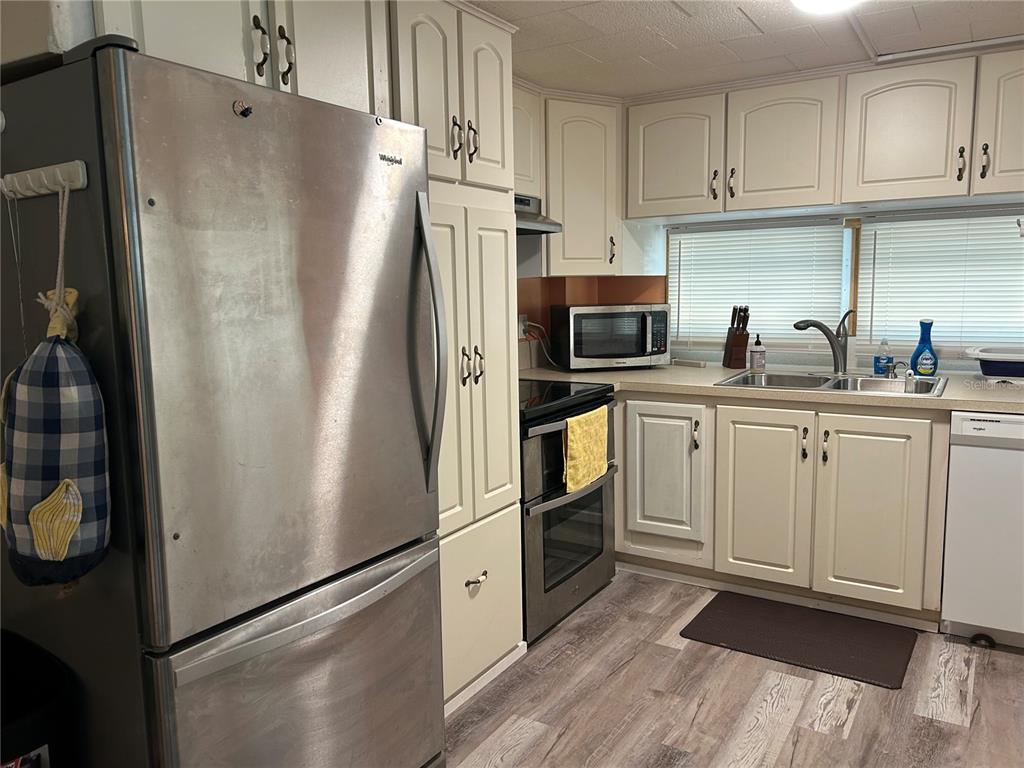 5325 Boca Raton Avenue Sarasota, FL 34234 - Photo 6 of 50 a kitchen with stainless steel appliances a refrigerator sink and microwave