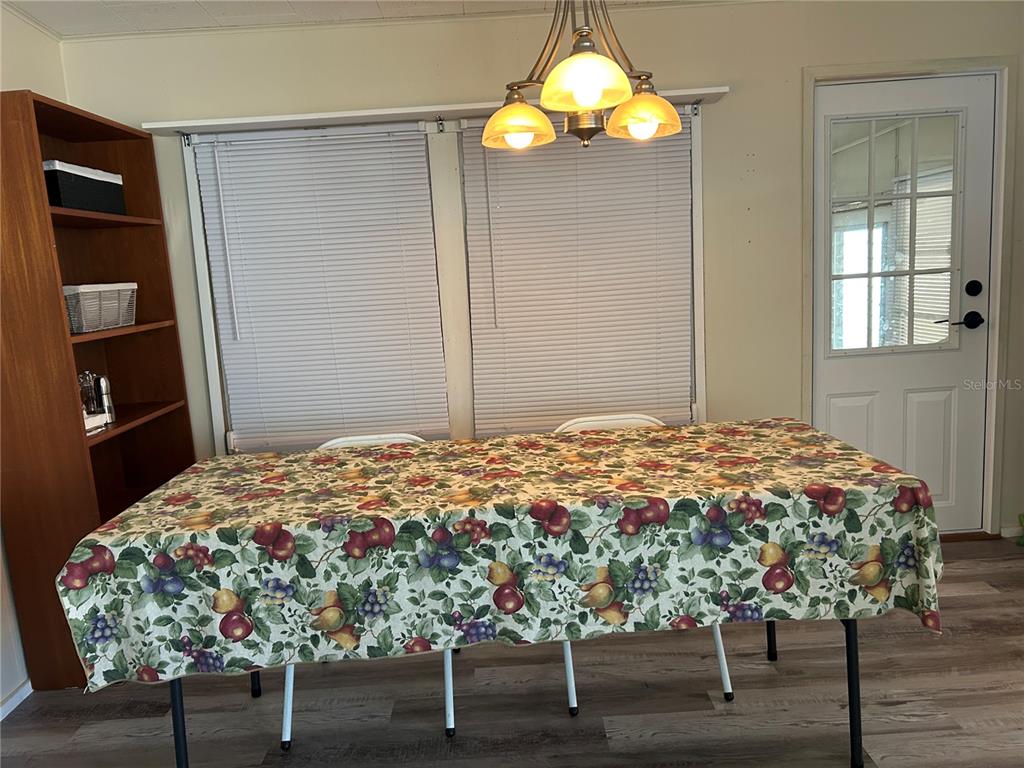 5325 Boca Raton Avenue Sarasota, FL 34234 - Photo 9 of 50 a bedroom with a bed and a chandelier