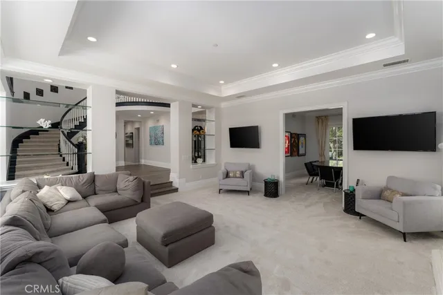 a dining room with furniture a chandelier and wooden floor