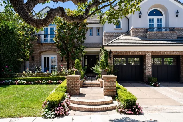 a front view of a house with a garden