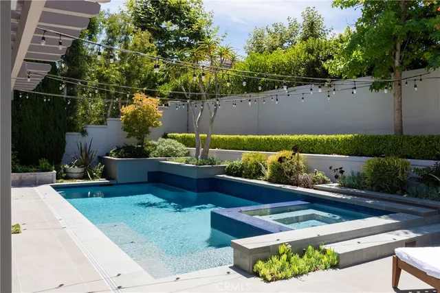 a view of a patio with table and chairs potted plants and large tree