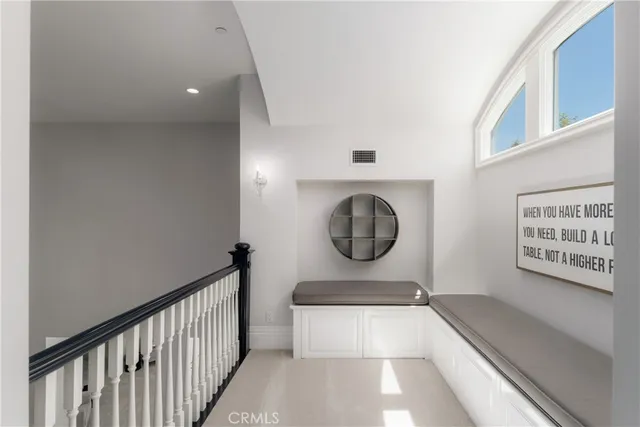 a bedroom with a bed a chandelier and a window