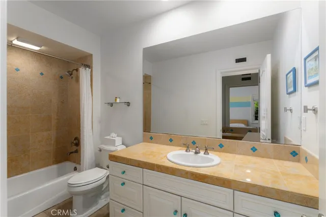 a bedroom with a bed and a night stand