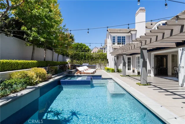 a view of a patio with couches table and chairs with wooden fence and plants