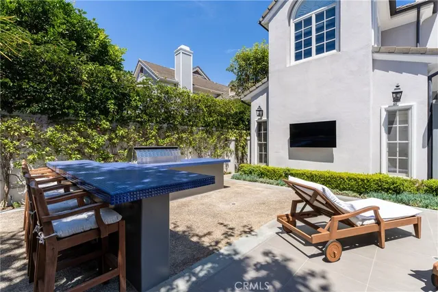 a view of a hallway with wooden floor and a living room