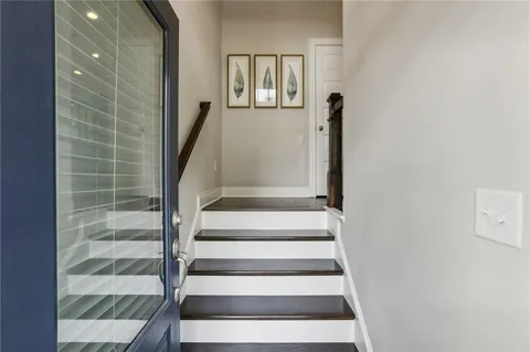 a view of staircase with white walls and windows