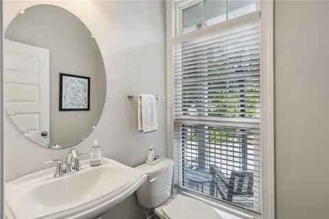 a bathroom with a sink a toilet and mirror