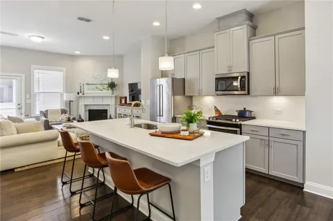 a kitchen with stainless steel appliances kitchen island granite countertop a sink and cabinets
