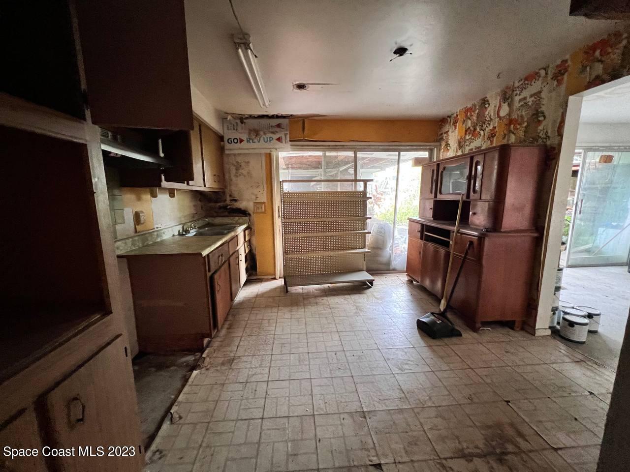 949 Levitt Parkway Rockledge, FL 32955 - Photo 5 of 5 a kitchen with stainless steel appliances granite countertop a refrigerator and a stove