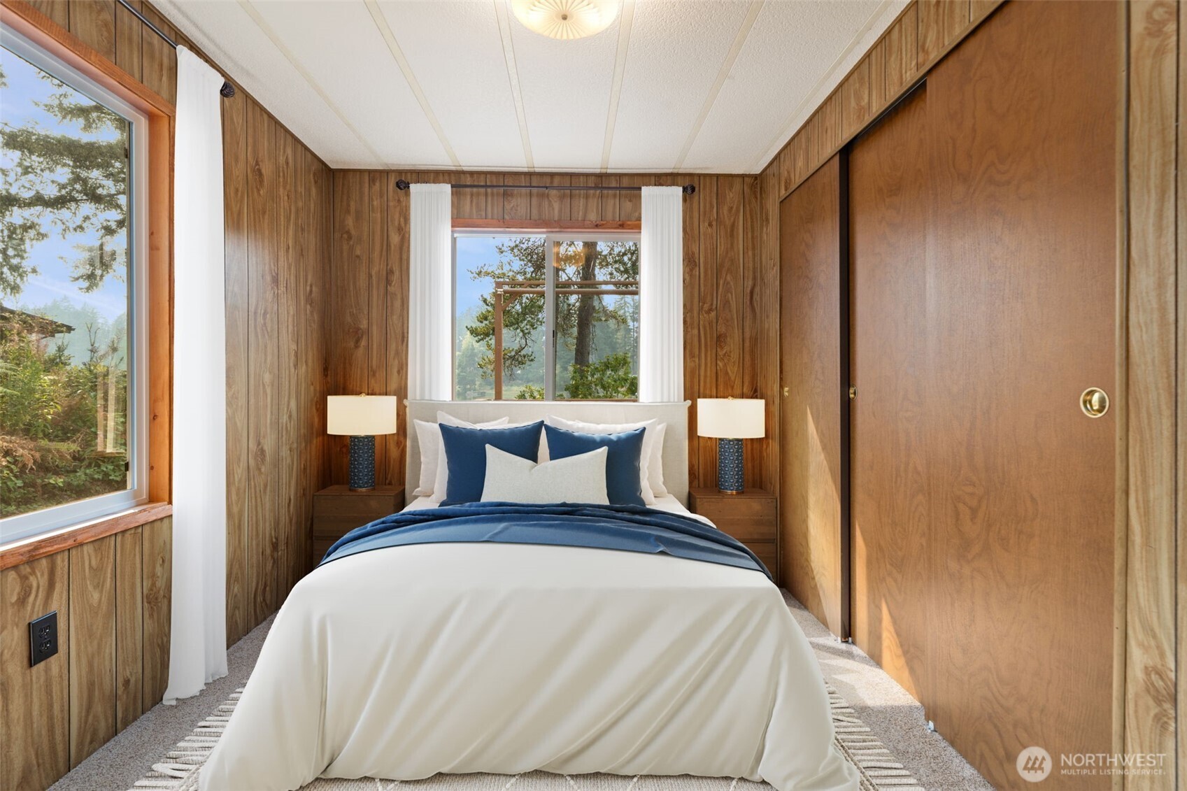 1171 E Trail Belfair, WA 98528 - Photo 11 of 29 a bedroom with a bed and a large window