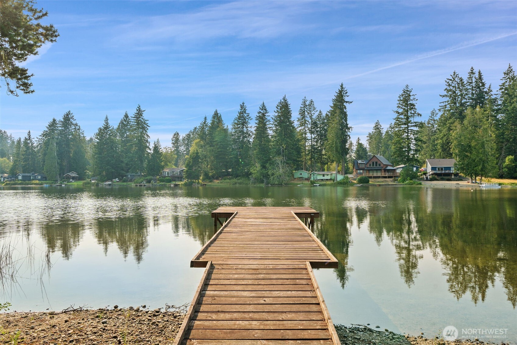 1171 E Trail Belfair, WA 98528 - Photo 17 of 29 a wooden pier with boats in a lake