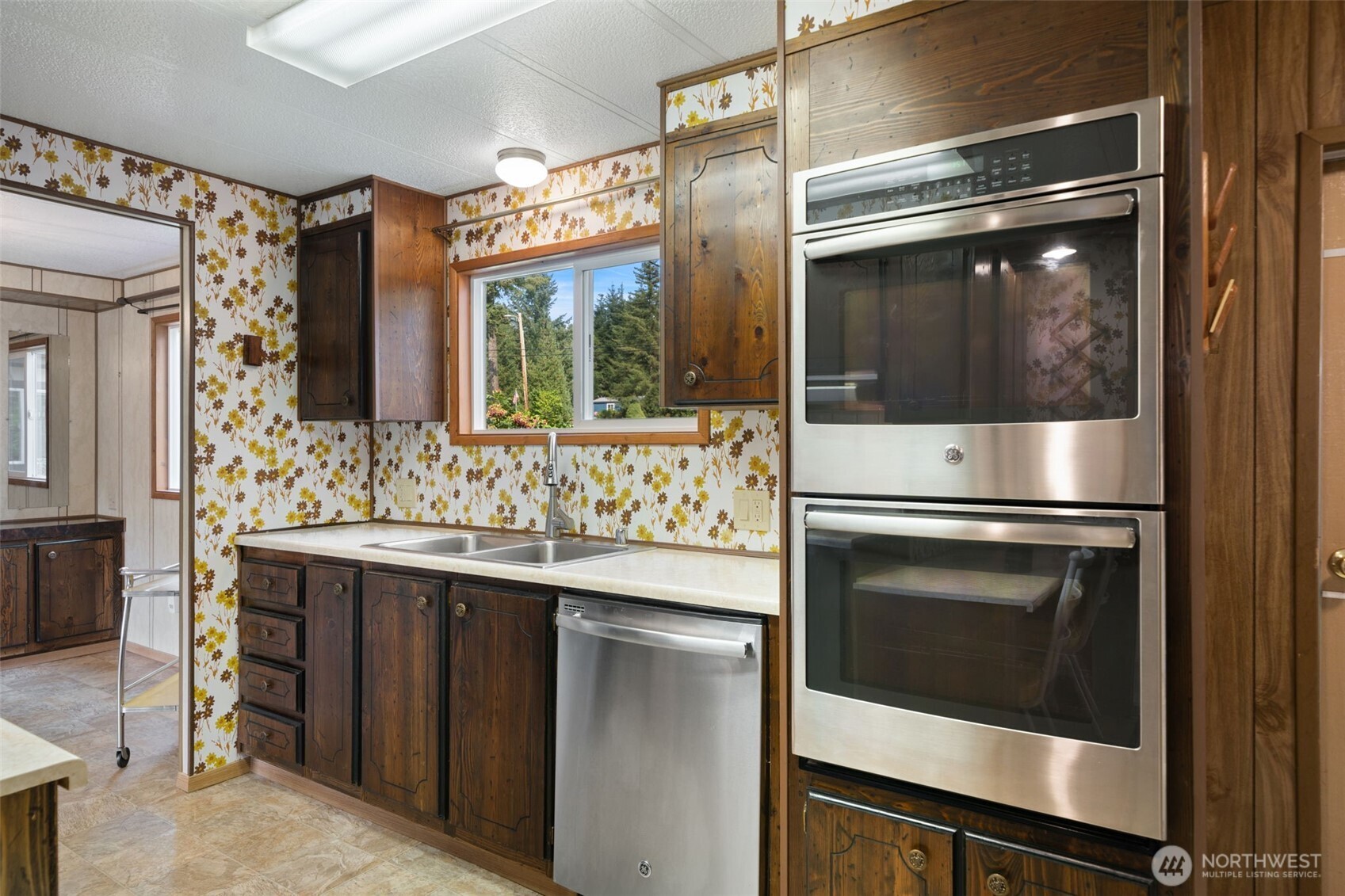 1171 E Trail Belfair, WA 98528 - Photo 6 of 29 a kitchen with stainless steel appliances a stove and a microwave
