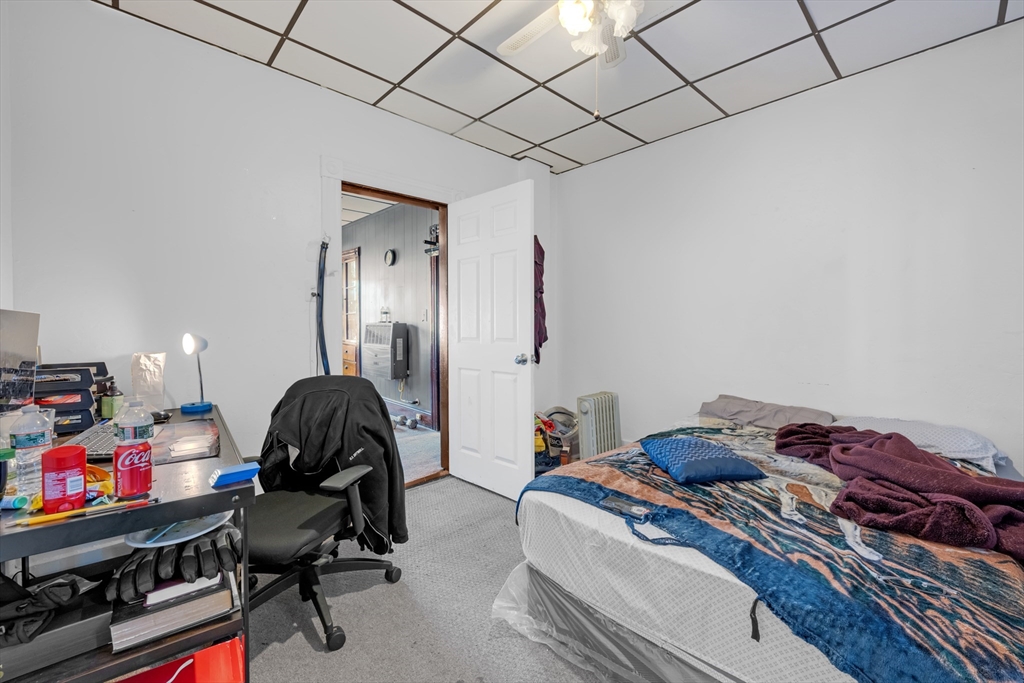14 Mendon Street Worcester, MA 01604 - Photo 15 of 17 a bedroom with a bed and a chandelier