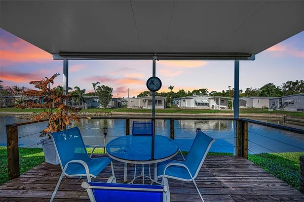 a view of a chairs and table in patio