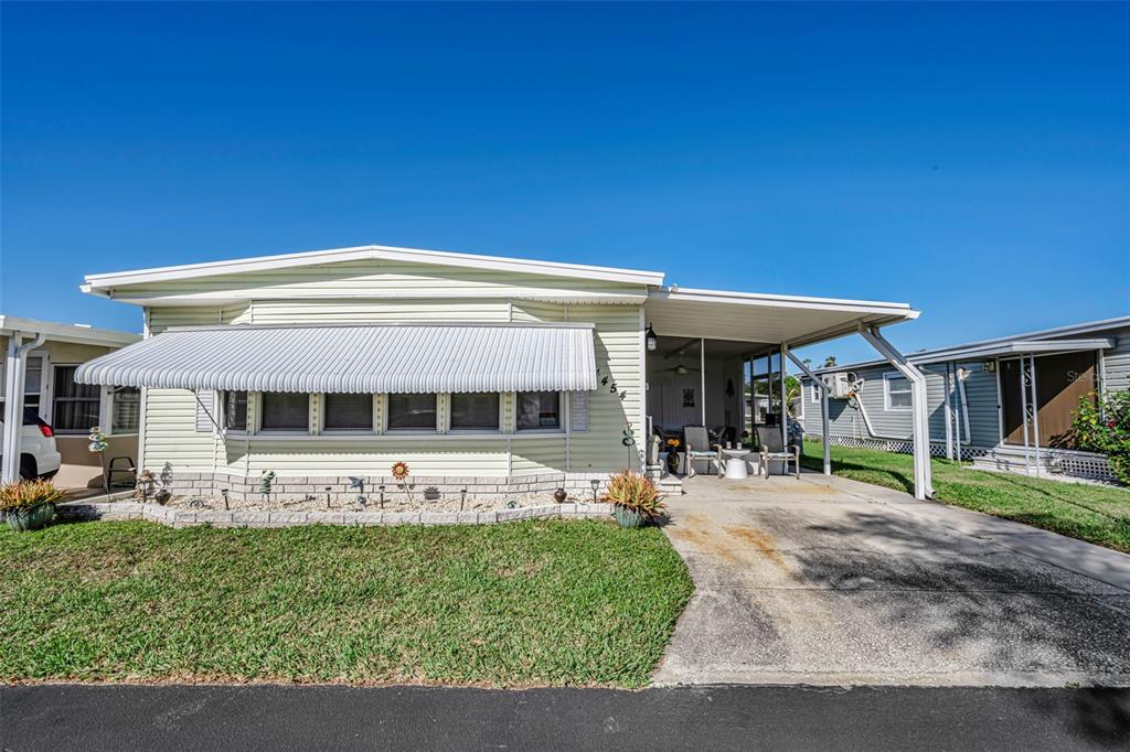 4454 Tucker Square New Port Richey, FL 34652 - Photo 11 of 64 a front view of a house with garden