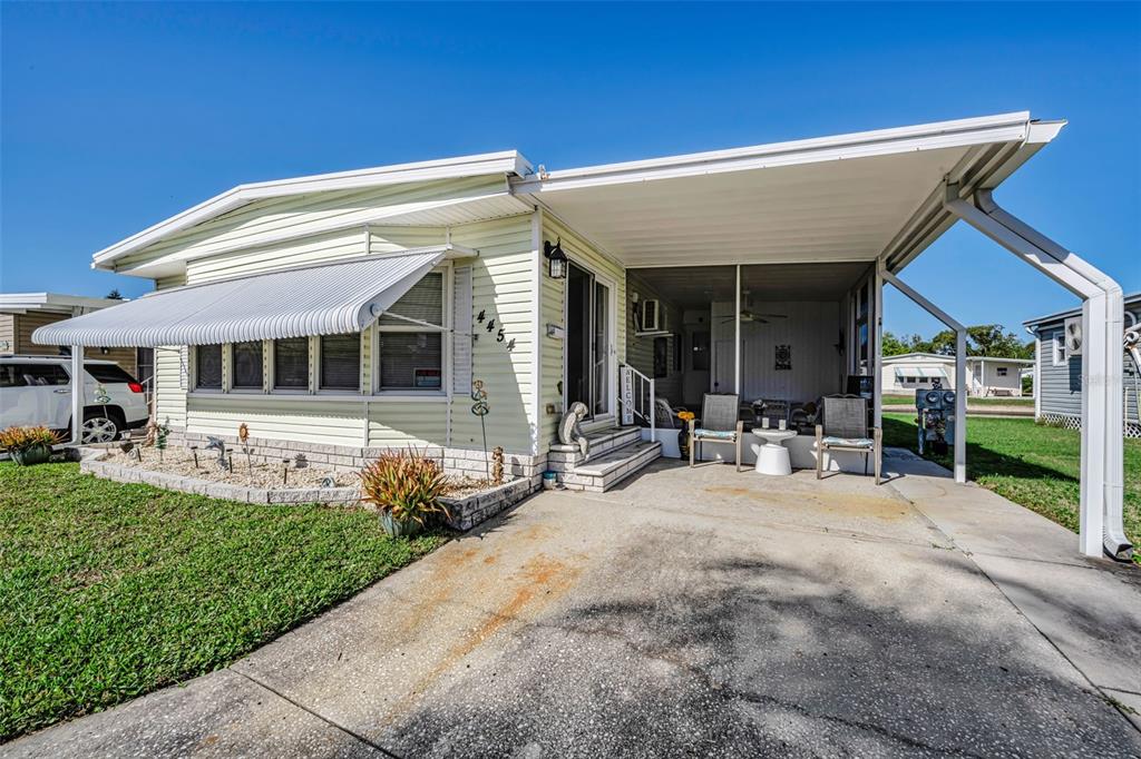 4454 Tucker Square New Port Richey, FL 34652 - Photo 12 of 64 a view of a house with sitting area and garden