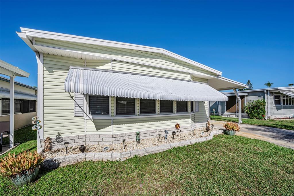 4454 Tucker Square New Port Richey, FL 34652 - Photo 13 of 64 a front view of a house with garden