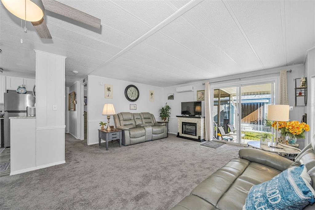 4454 Tucker Square New Port Richey, FL 34652 - Photo 17 of 64 a living room with furniture and a flat screen tv