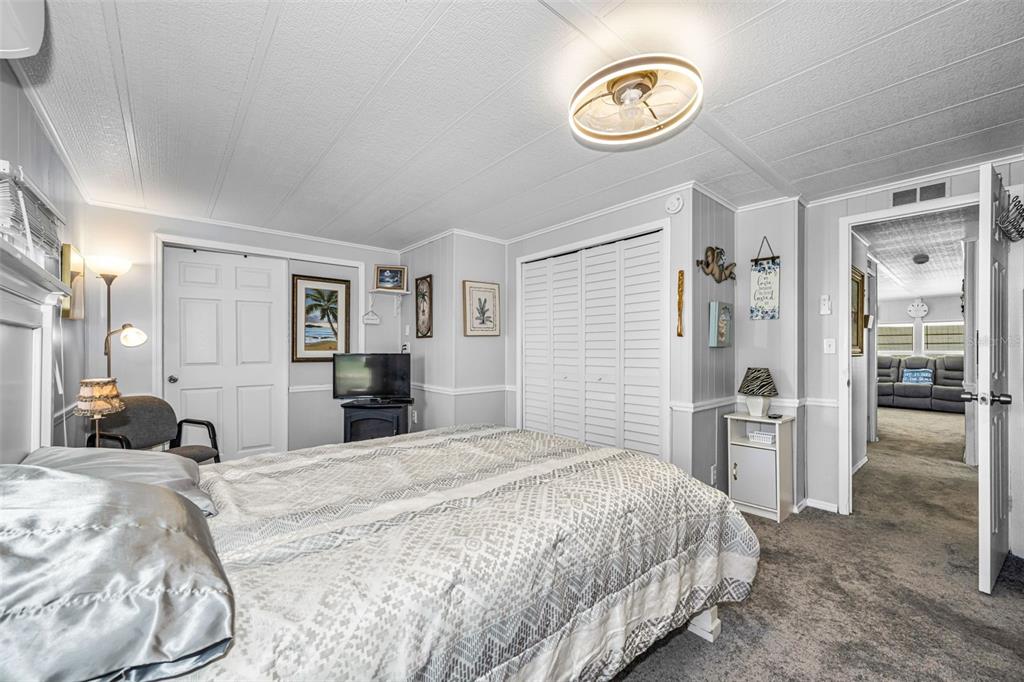 4454 Tucker Square New Port Richey, FL 34652 - Photo 23 of 64 a bedroom with a large bed and a chandelier