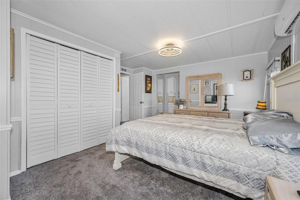 4454 Tucker Square New Port Richey, FL 34652 - Photo 24 of 64 a spacious bedroom with a bed and walk in closet