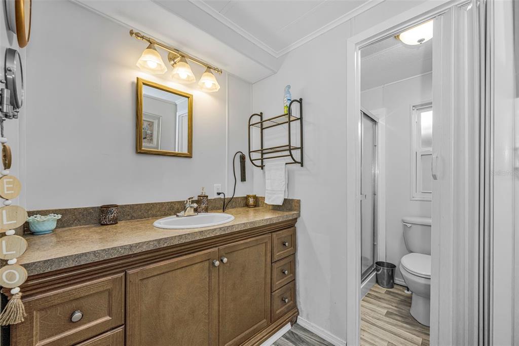 4454 Tucker Square New Port Richey, FL 34652 - Photo 25 of 64 a en suite bathroom with a granite countertop sink and a mirror