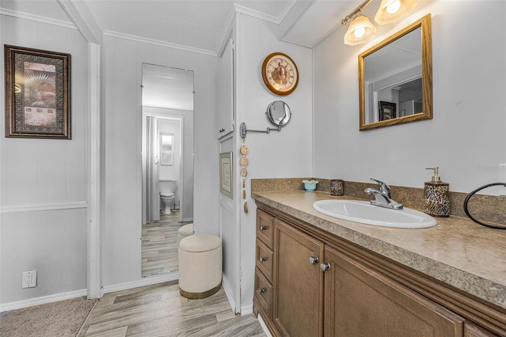 4454 Tucker Square New Port Richey, FL 34652 - Photo 26 of 64 a bathroom with a granite countertop sink and a mirror