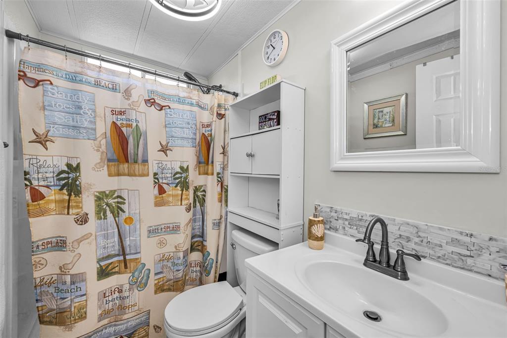 4454 Tucker Square New Port Richey, FL 34652 - Photo 28 of 64 a bathroom with a sink toilet and shower