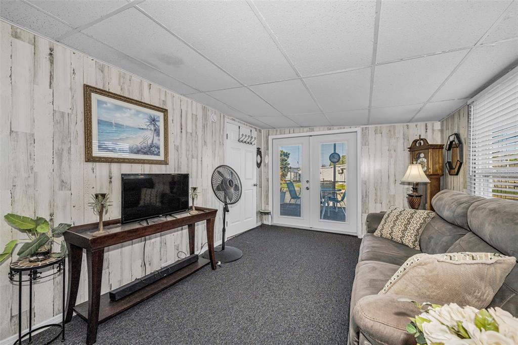 4454 Tucker Square New Port Richey, FL 34652 - Photo 29 of 64 a living room with furniture and a flat screen tv