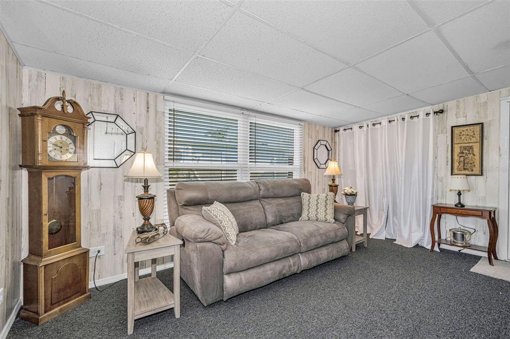 4454 Tucker Square New Port Richey, FL 34652 - Photo 30 of 64 a living room with furniture a desk and chair with the potted plants