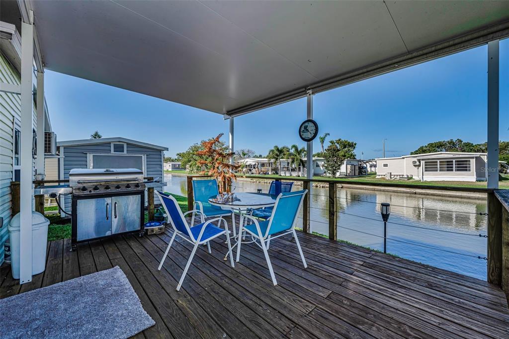 4454 Tucker Square New Port Richey, FL 34652 - Photo 34 of 64 a dining room with furniture a rug and wooden floor