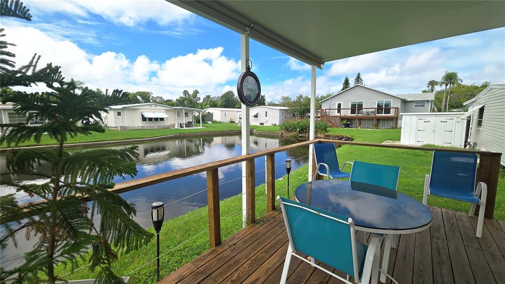 4454 Tucker Square New Port Richey, FL 34652 - Photo 35 of 64 a view of a chairs and table in patio with a yard