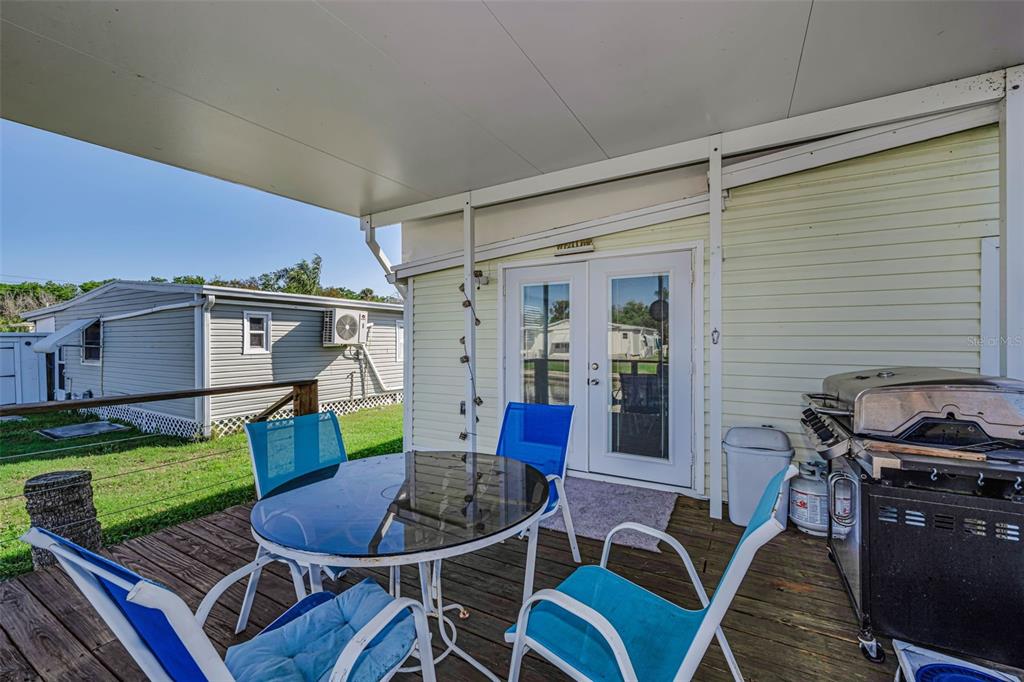 4454 Tucker Square New Port Richey, FL 34652 - Photo 36 of 64 a view of a patio with couches chairs and a potted plant