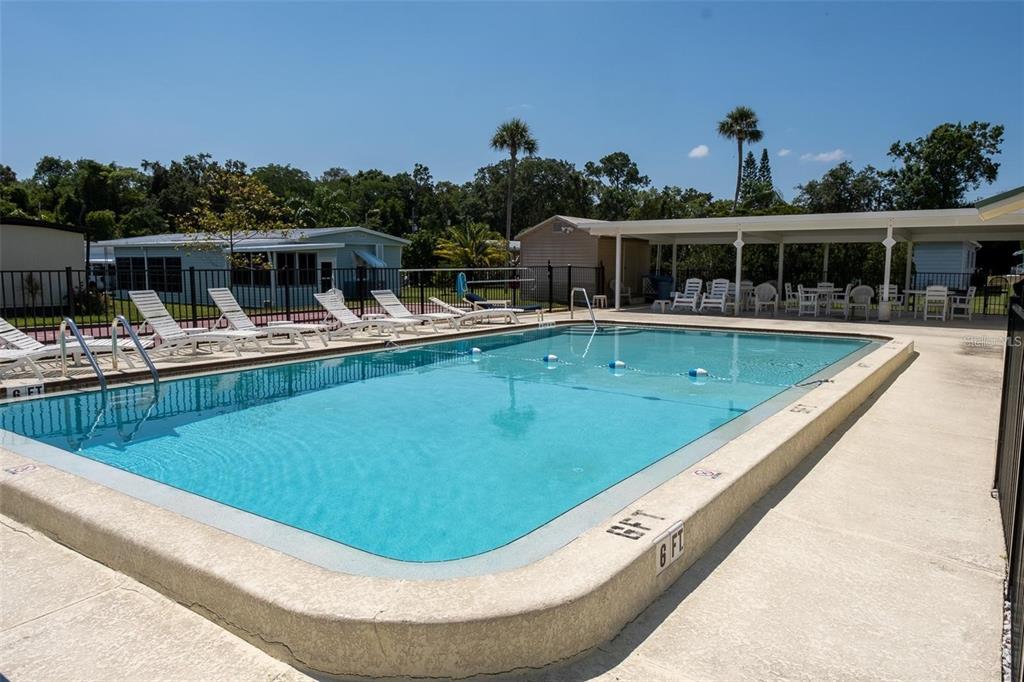 4454 Tucker Square New Port Richey, FL 34652 - Photo 43 of 64 a view of a swimming pool with a deck