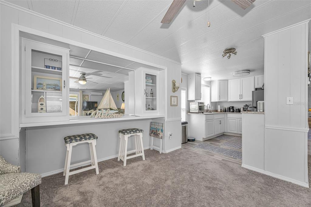 4454 Tucker Square New Port Richey, FL 34652 - Photo 7 of 64 a open kitchen with white cabinets and stainless steel appliances