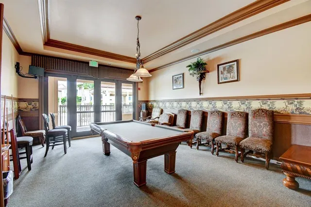 a room with gym equipment and a chandelier