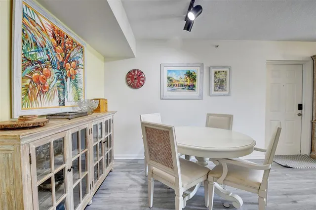 a view of a dining room with furniture wooden floor and a chandelier