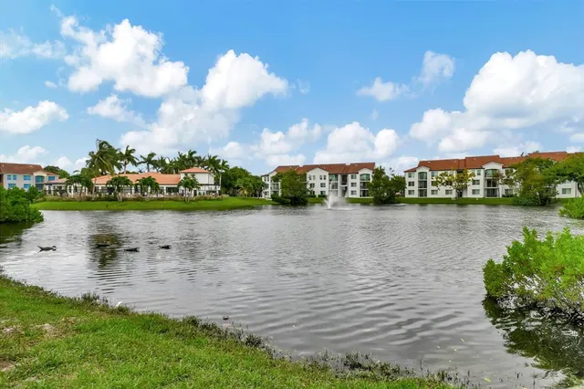 a view of a lake with houses in the back