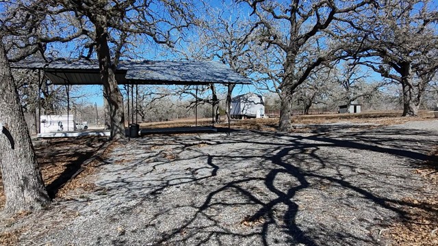 266 Catfish Lane Lockhart, TX 78644 - Photo 4 of 7 a view of a yard with wooden fence