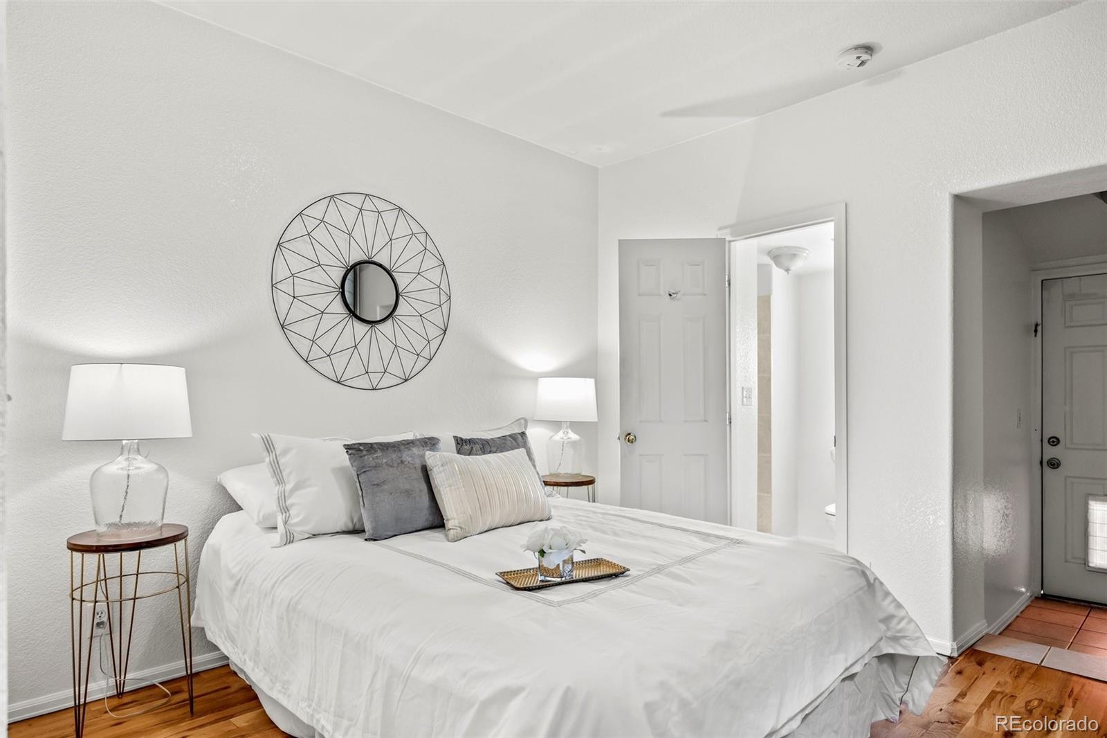 323 Inca Street Denver, CO 80223 - Photo 13 of 27 a bedroom with bed and a lamp
