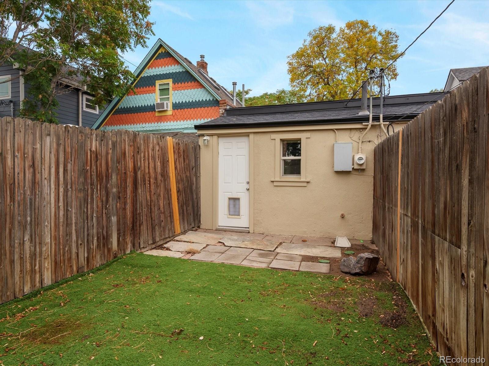 323 Inca Street Denver, CO 80223 - Photo 19 of 27 a backyard of a house with table and chairs