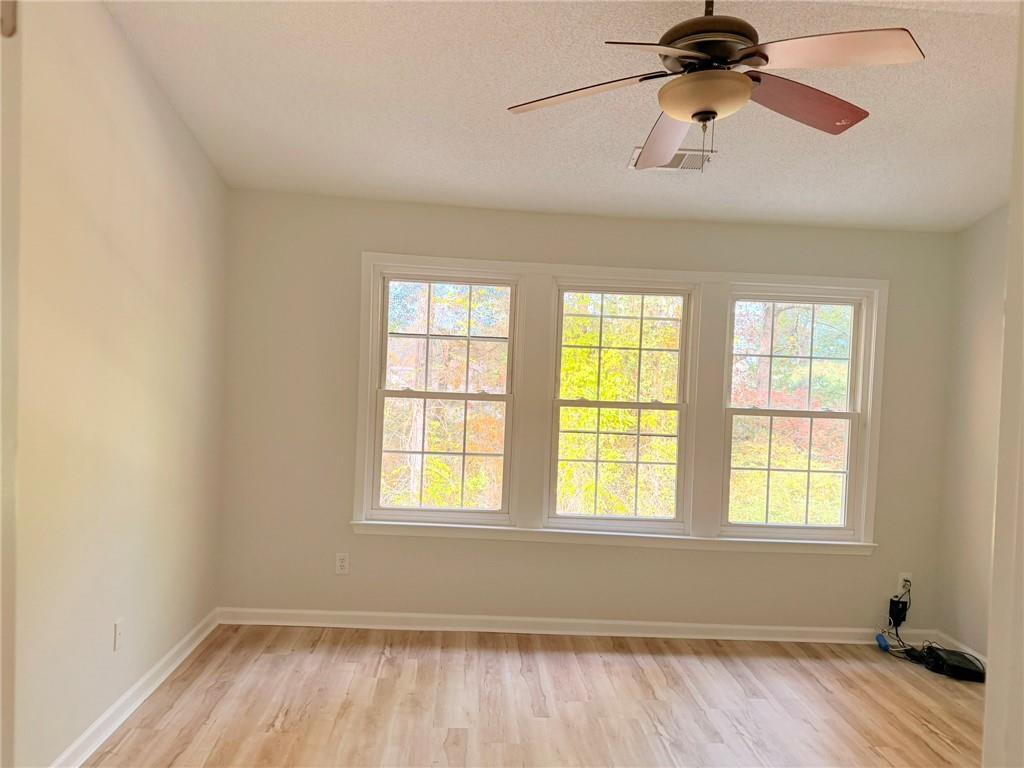 10900 Wittenridge Drive, Unit C7 Alpharetta, GA 30022 - Photo 16 of 31 a view of room with a ceiling fan and window