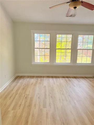 a view of an empty room with wooden floor