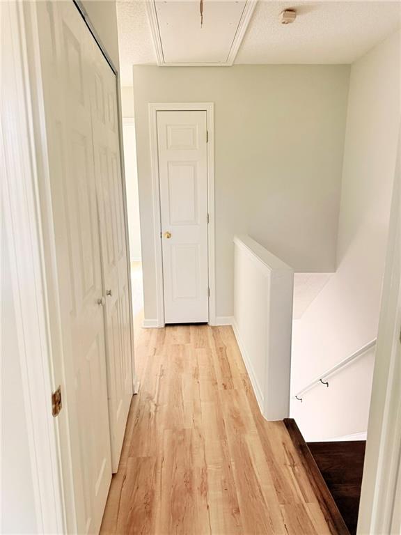 10900 Wittenridge Drive, Unit C7 Alpharetta, GA 30022 - Photo 23 of 31 a view of a hallway with wooden floor and staircase