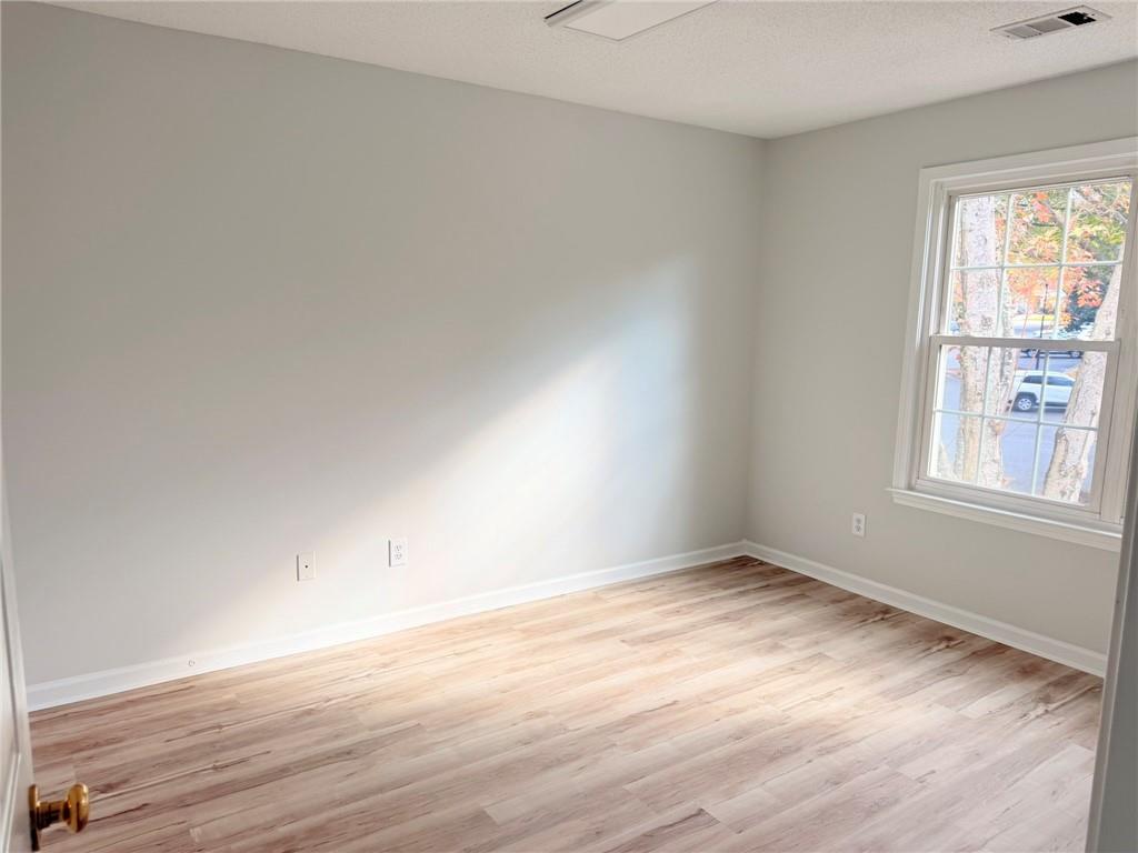 10900 Wittenridge Drive, Unit C7 Alpharetta, GA 30022 - Photo 25 of 31 an empty room with wooden floor and windows