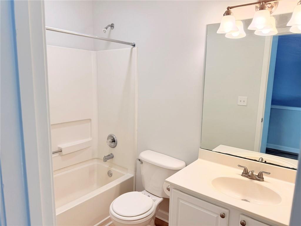 10900 Wittenridge Drive, Unit C7 Alpharetta, GA 30022 - Photo 27 of 31 a bathroom with a sink a toilet and shower