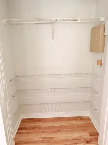 wooden floor fireplace and windows in an empty room