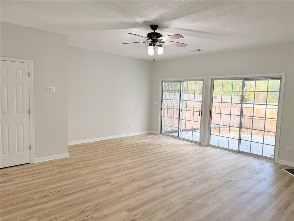 10900 Wittenridge Drive, Unit C7 Alpharetta, GA 30022 - Photo 10 of 31 a view of an empty room with window and wooden floor