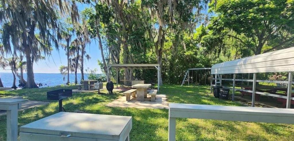 731 Paradise Boulevard Georgetown, FL 32139 - Photo 14 of 15 a backyard of a house with barbeque oven table and chairs